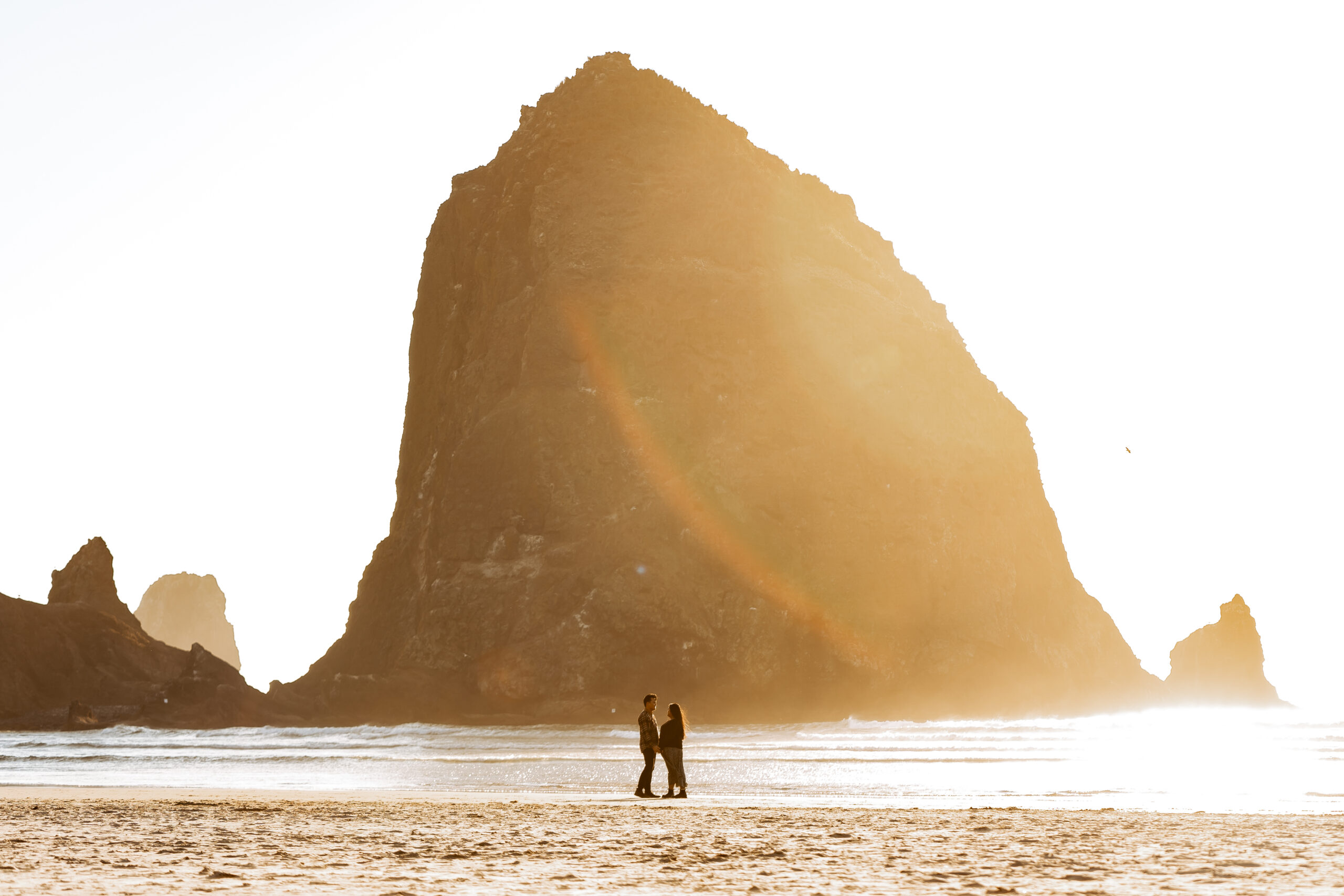 couple posing for cannon beach engagement photo shoot