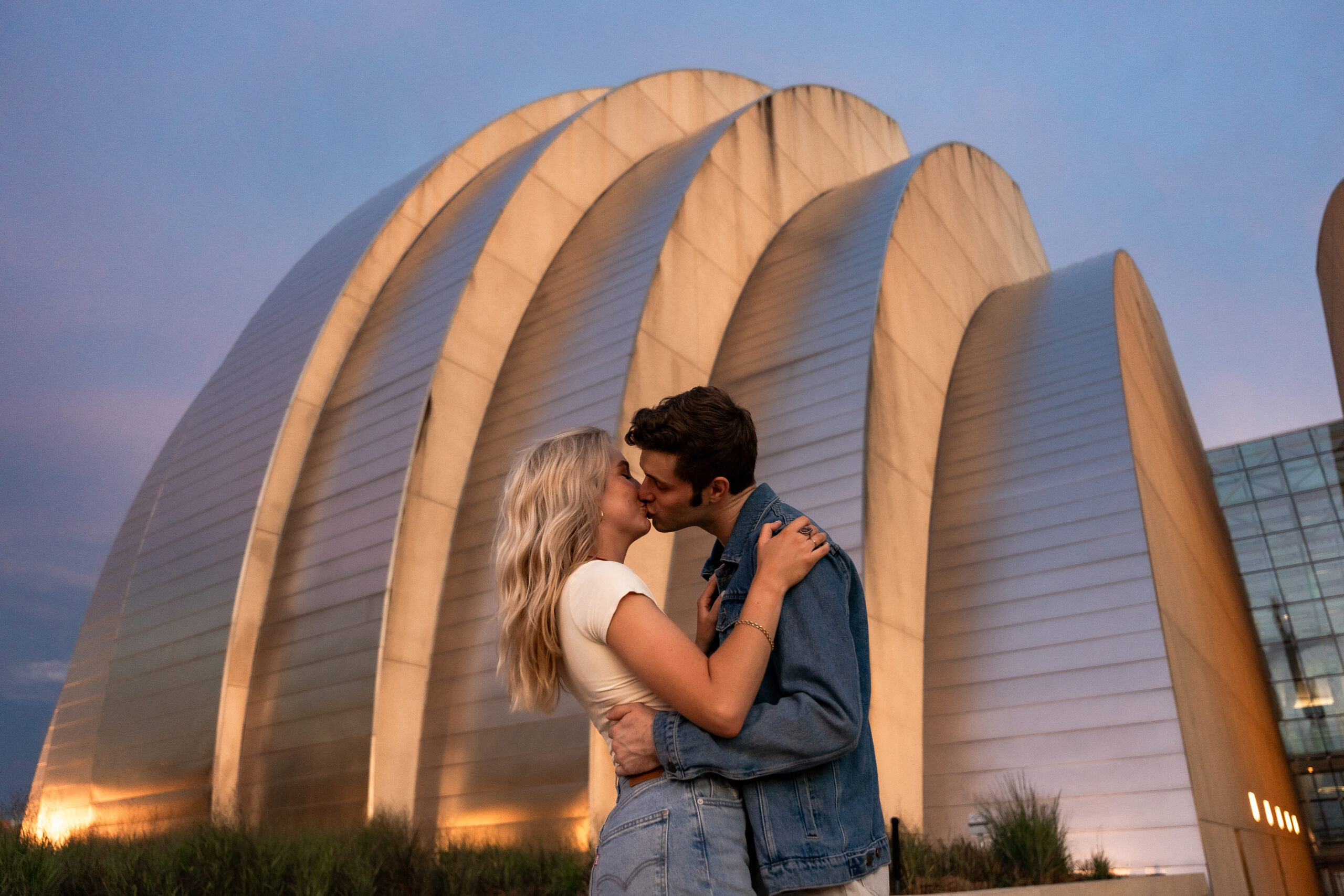 couple kissing at the kauffman center for their engagement session
