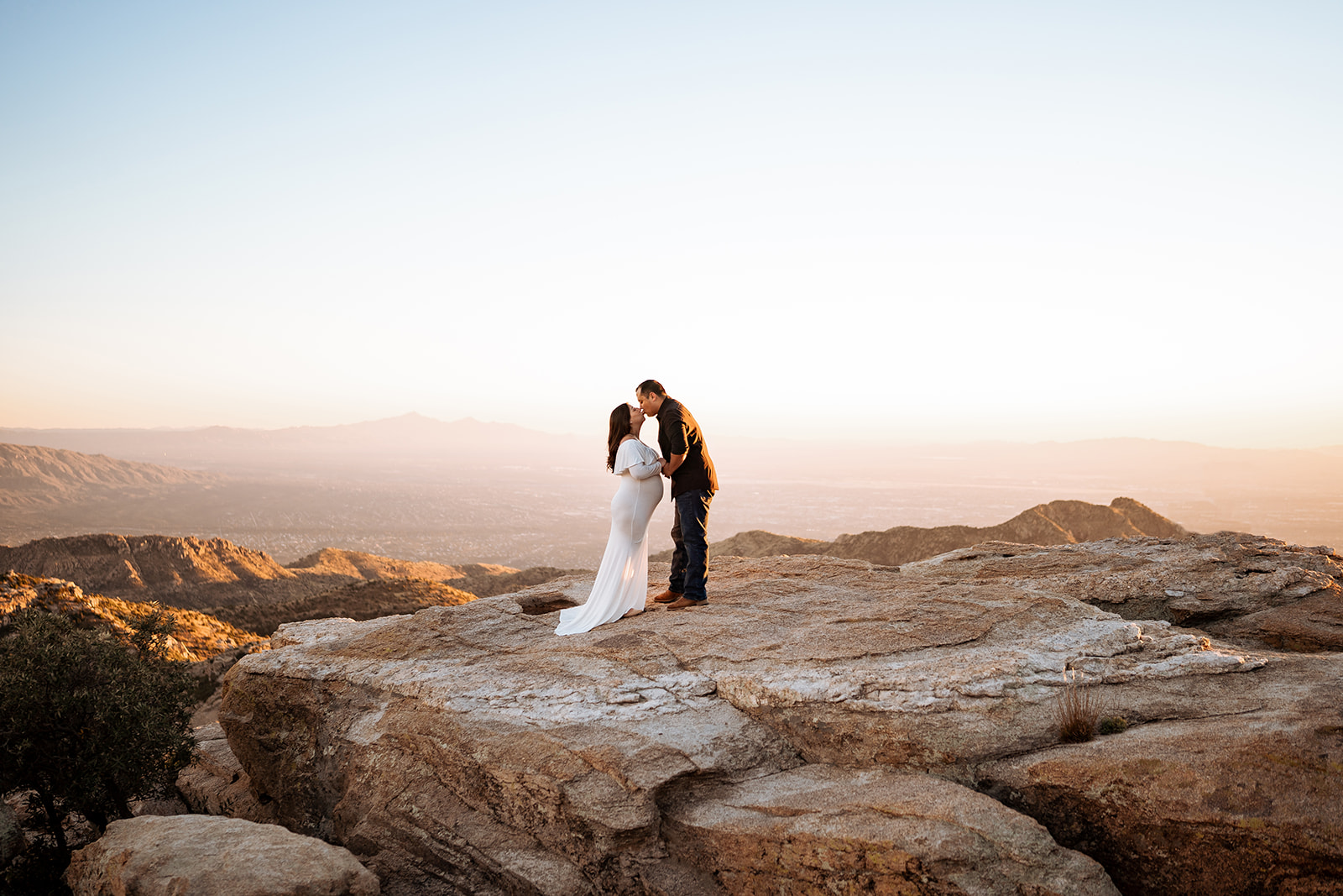 couple posing for sunset maternity photos at Windy Point on Mount Lemmon near Tucson, Arizona